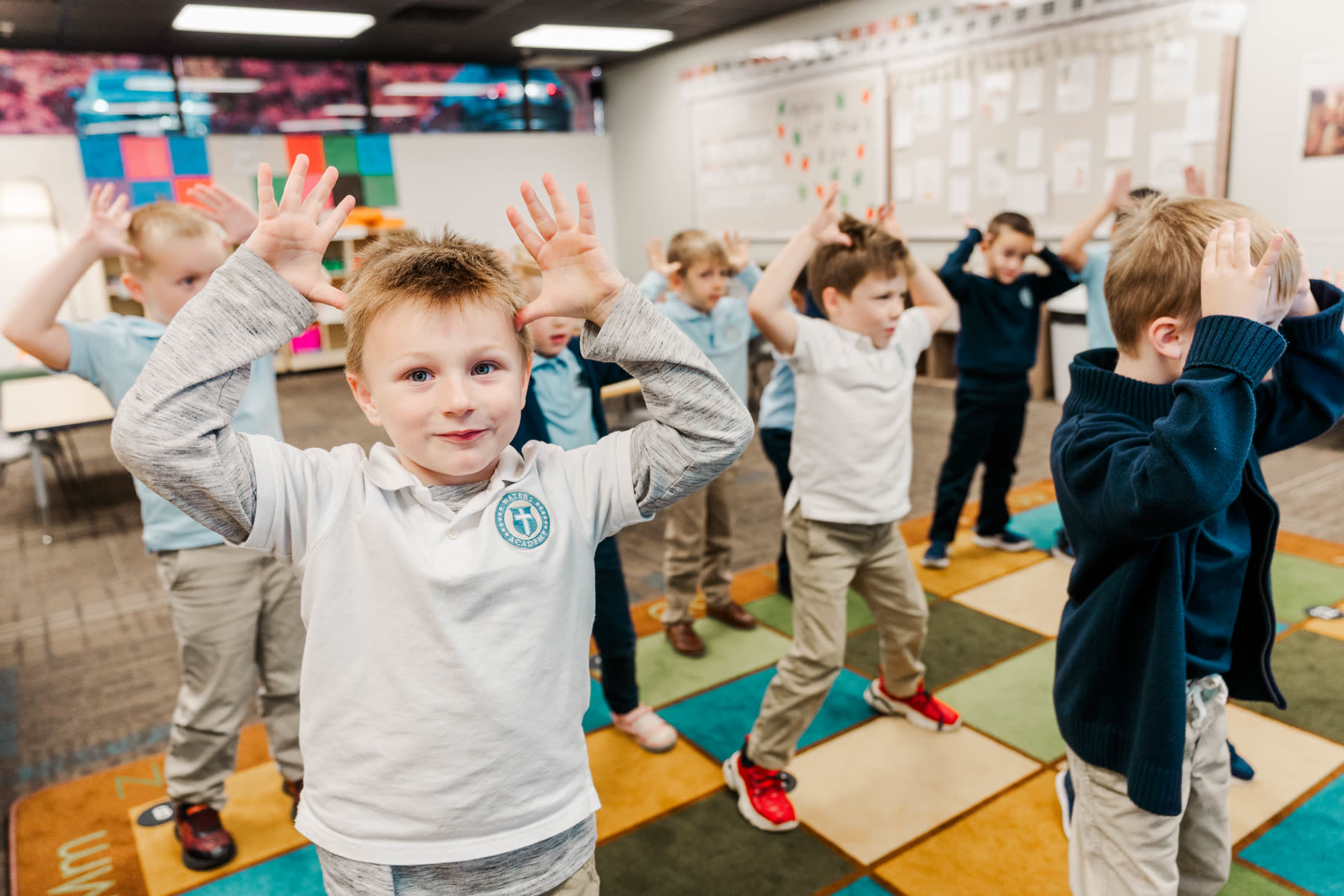 A Waters Academy student smiling and engaged during a classroom activity